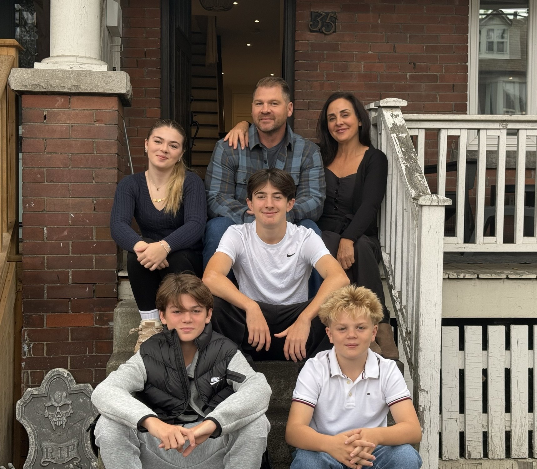 Bryan Stott with his family on the front steps of their home in Stouffville